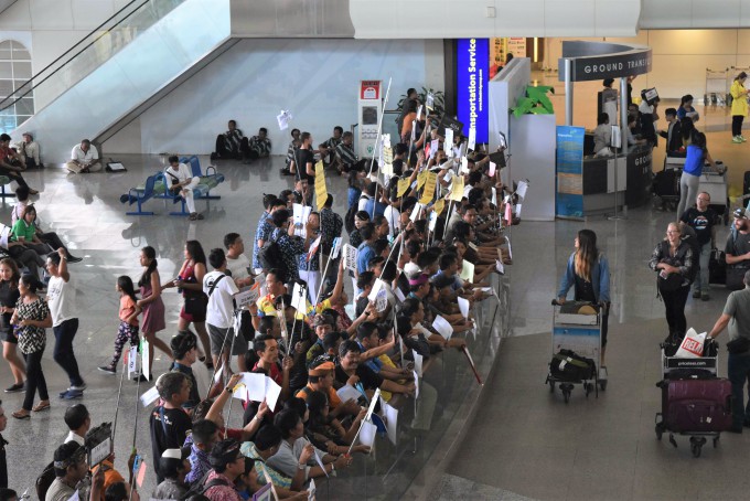 ングラ・ライ国際空港で観光客を待つ沢山のガイド