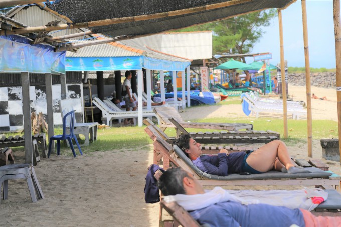 スランガンビーチでビーチベッドに座る観光客